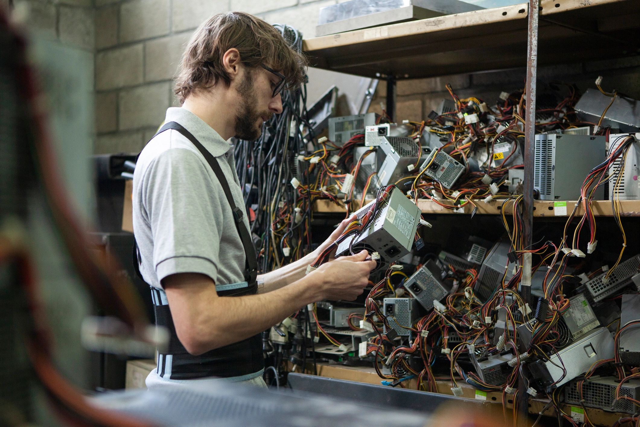 Technician inspecting internal electronic components