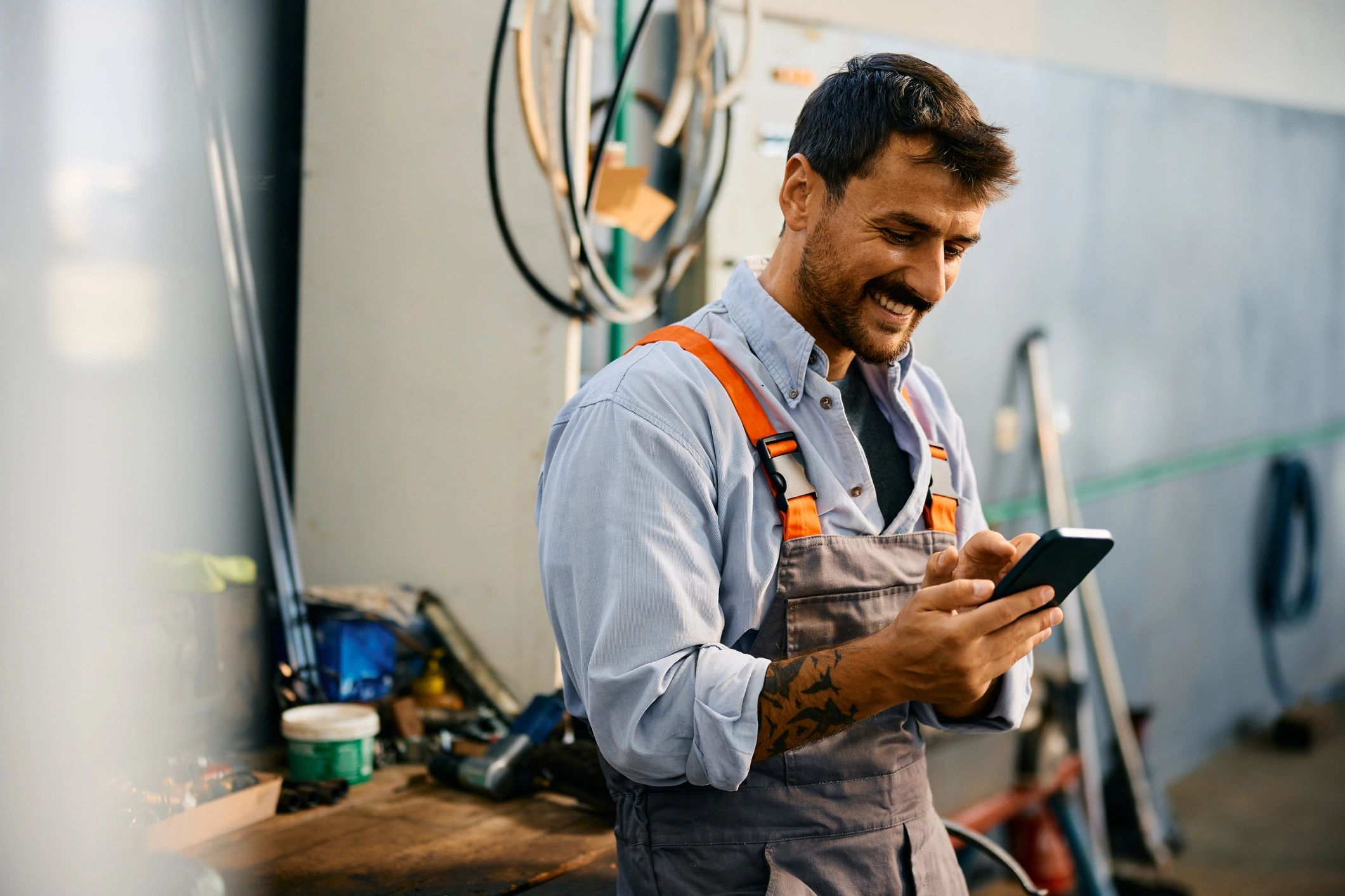 Repair shop technician holding a smartphone