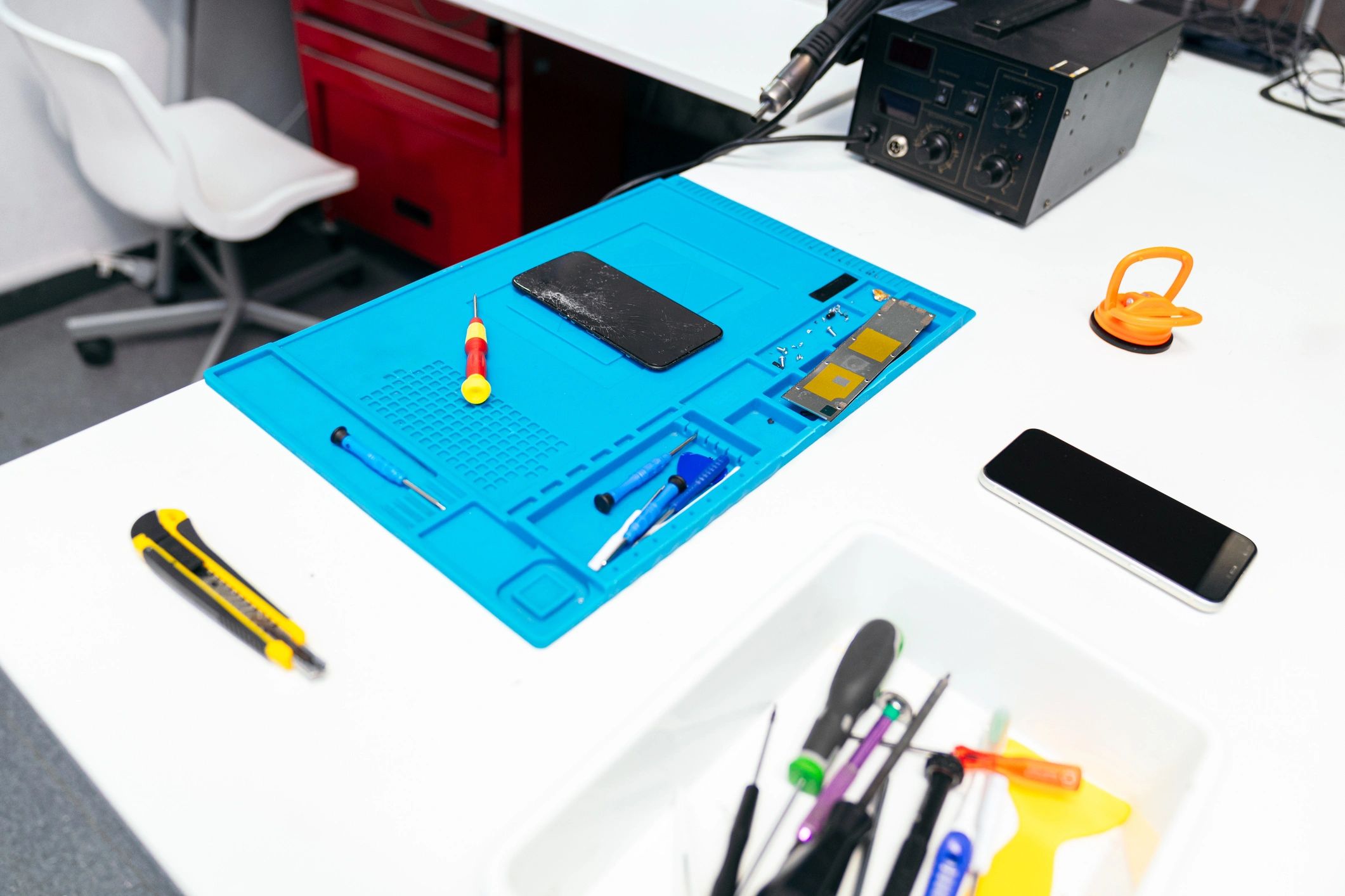 Mobile phone repair workstation with tools and devices
