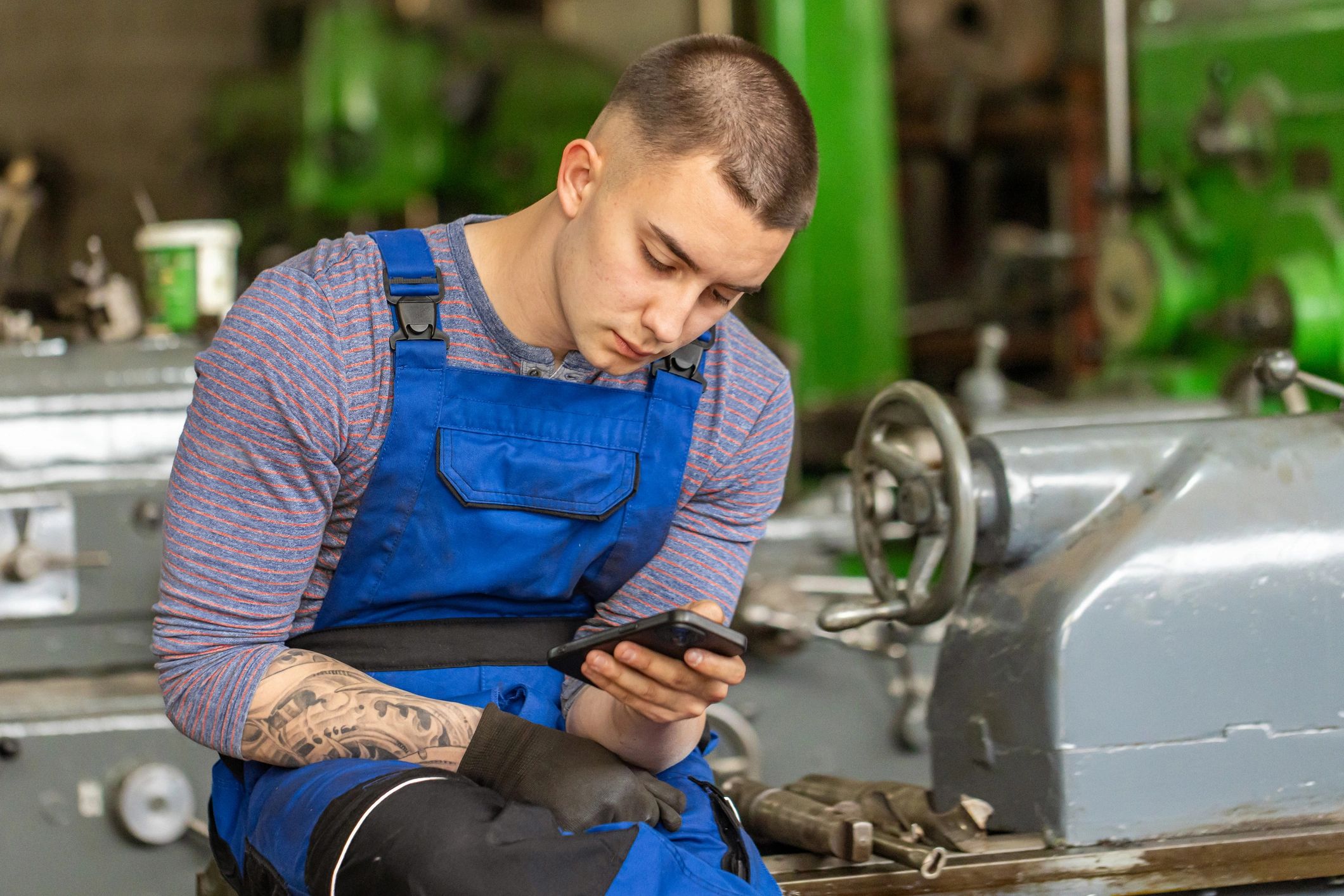 Technician using a smartphone in a repair shop